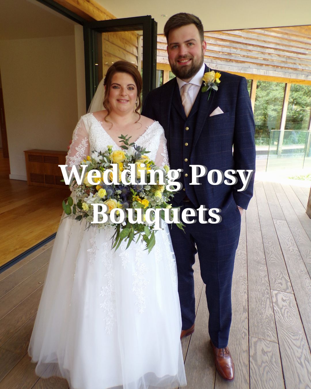 The bride, in a white gown a bouquet of yellow and white flowers. The groom wears a dark suit